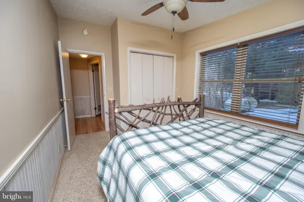 a bed sitting in a bedroom next to a window
