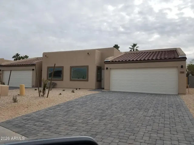 a kitchen with granite countertop a sink and cabinets