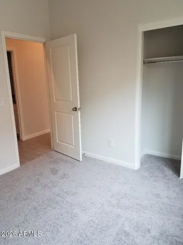 a bathroom with a granite countertop sink a toilet and a mirror