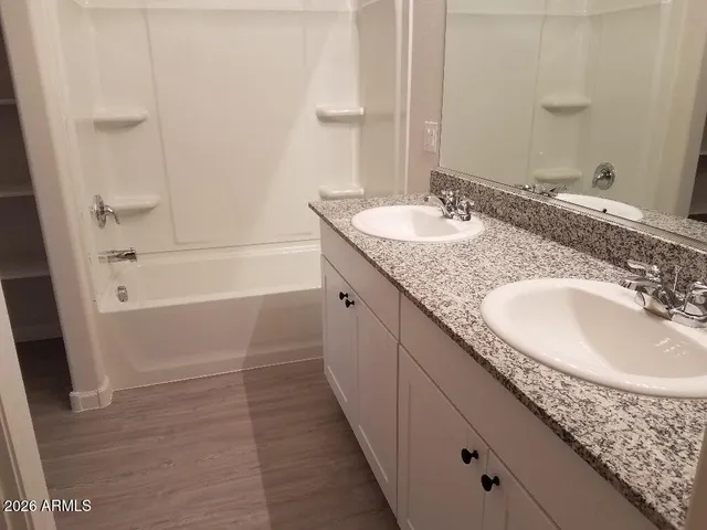 a bathroom with a granite countertop toilet and a shower