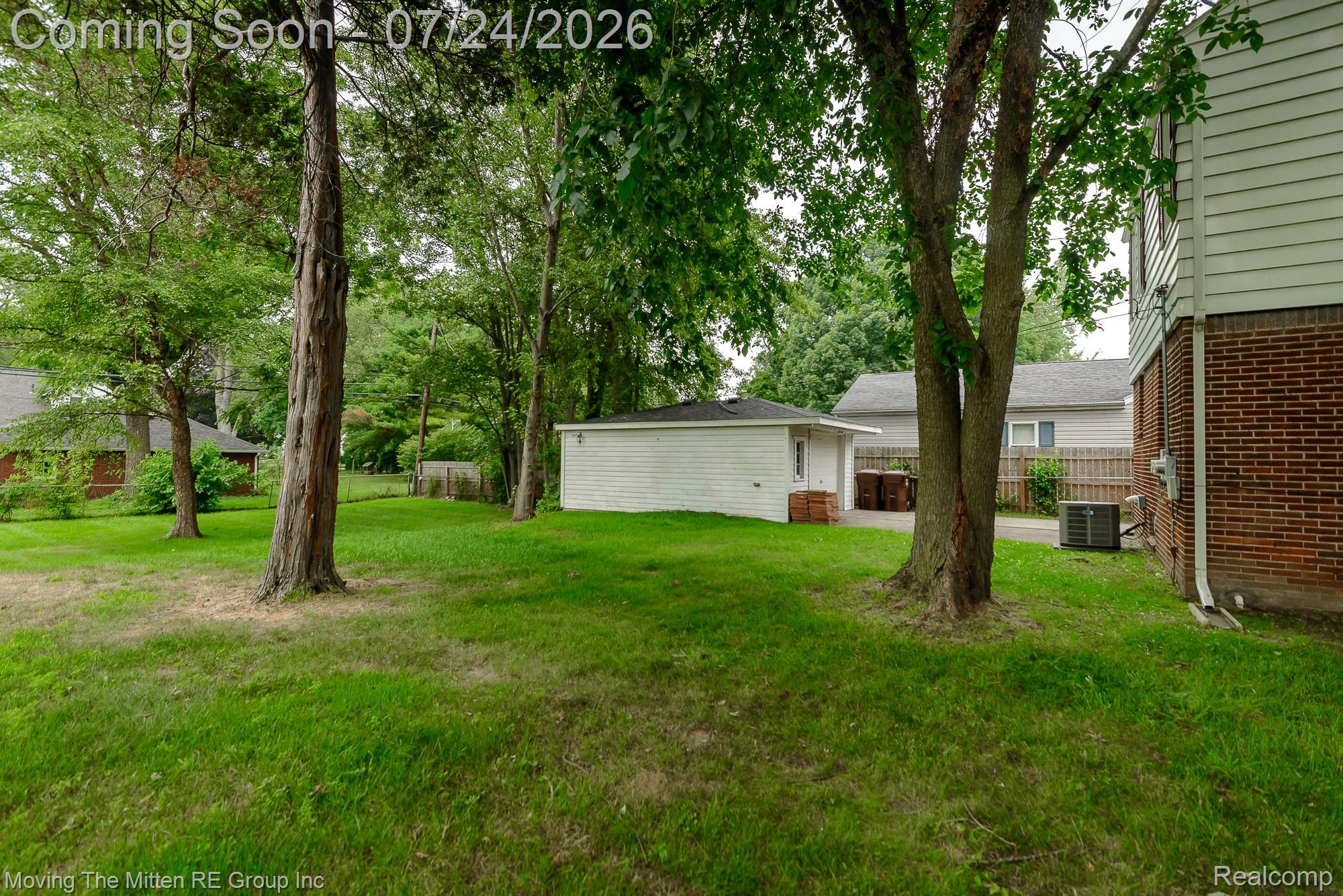 2037 Vivian Road Monroe, MI 48162 - Photo 2 of 39 Expansive green lawn with mature trees