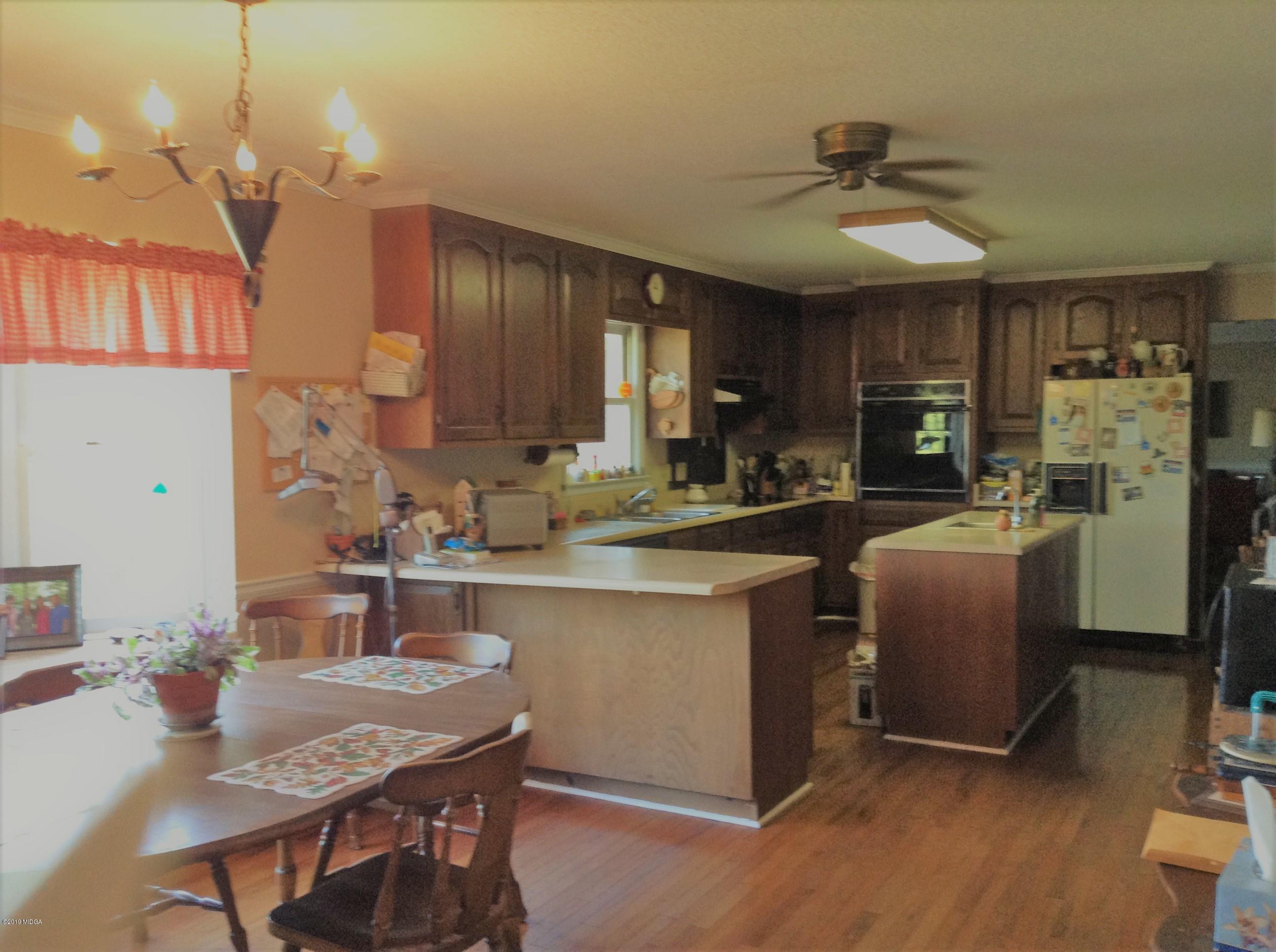 1661 Bonner Gilbert Road Macon, GA 31220 - Photo 11 of 15 a kitchen with sink cabinets and wooden floor