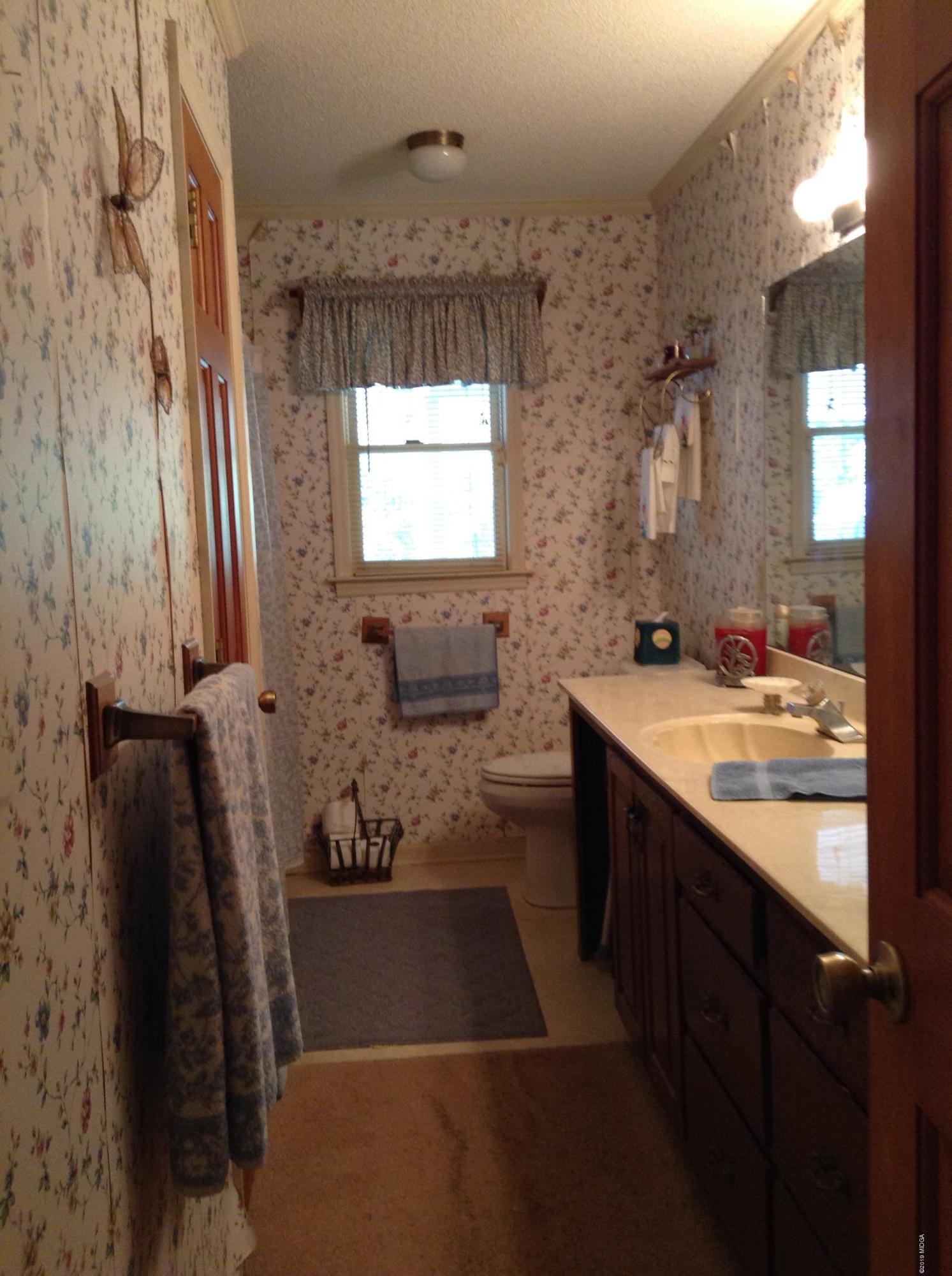 1661 Bonner Gilbert Road Macon, GA 31220 - Photo 6 of 15 a bathroom with a tub sink and mirror