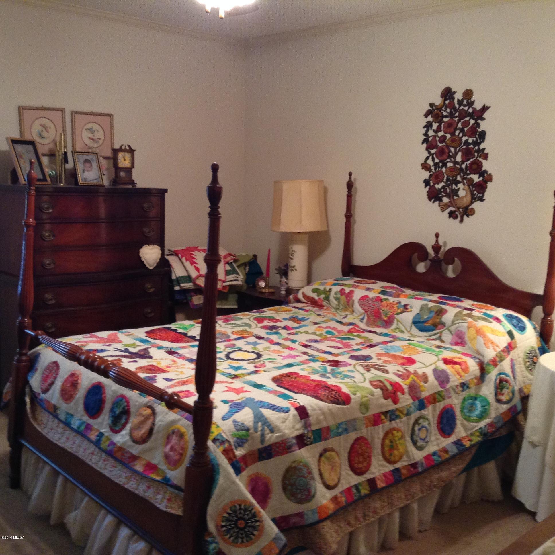 1661 Bonner Gilbert Road Macon, GA 31220 - Photo 7 of 15 a bedroom with a bed that has a blanket and pillows