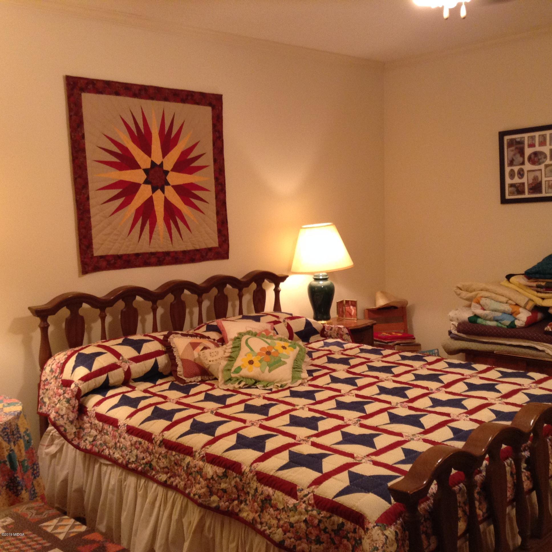 1661 Bonner Gilbert Road Macon, GA 31220 - Photo 8 of 15 a bed sitting in a bedroom next to a lamp
