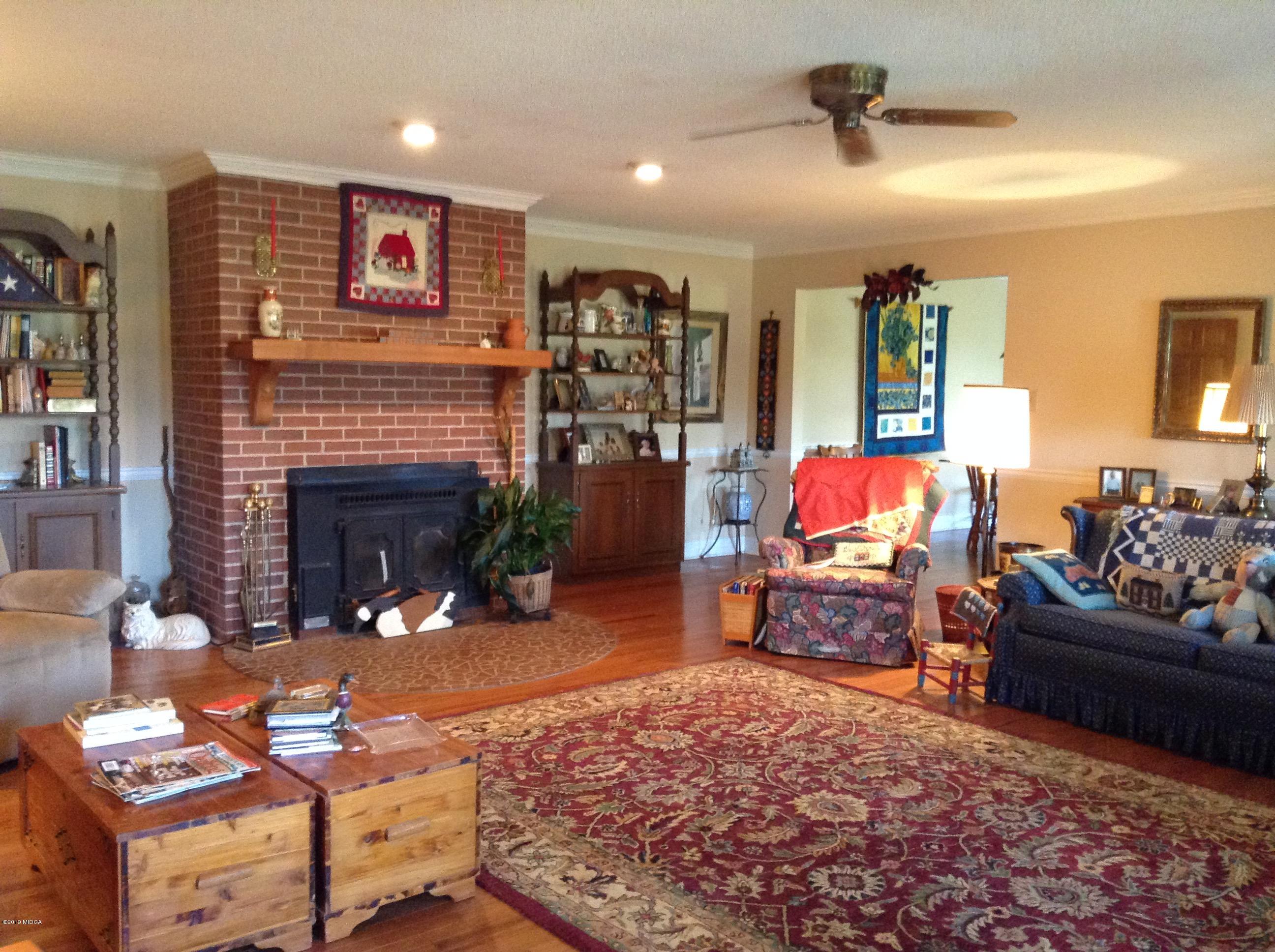 1661 Bonner Gilbert Road Macon, GA 31220 - Photo 10 of 15 a living room with furniture and a fireplace