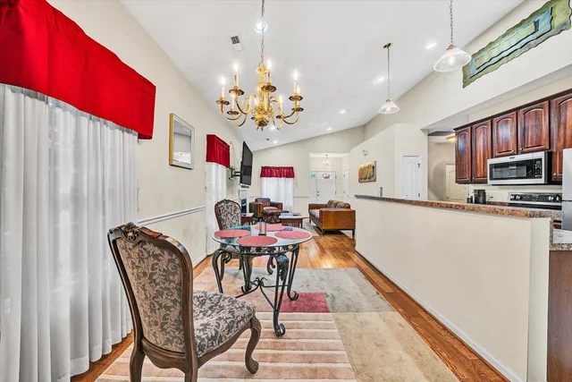 a view of a dining room with furniture and chandelier