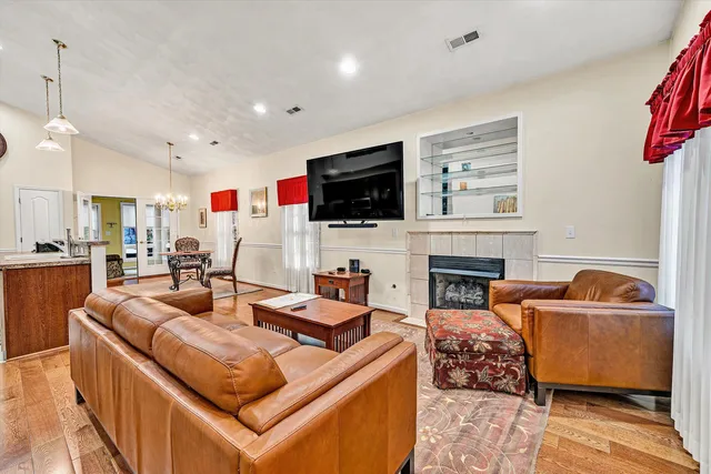 a living room with fireplace furniture and a flat screen tv