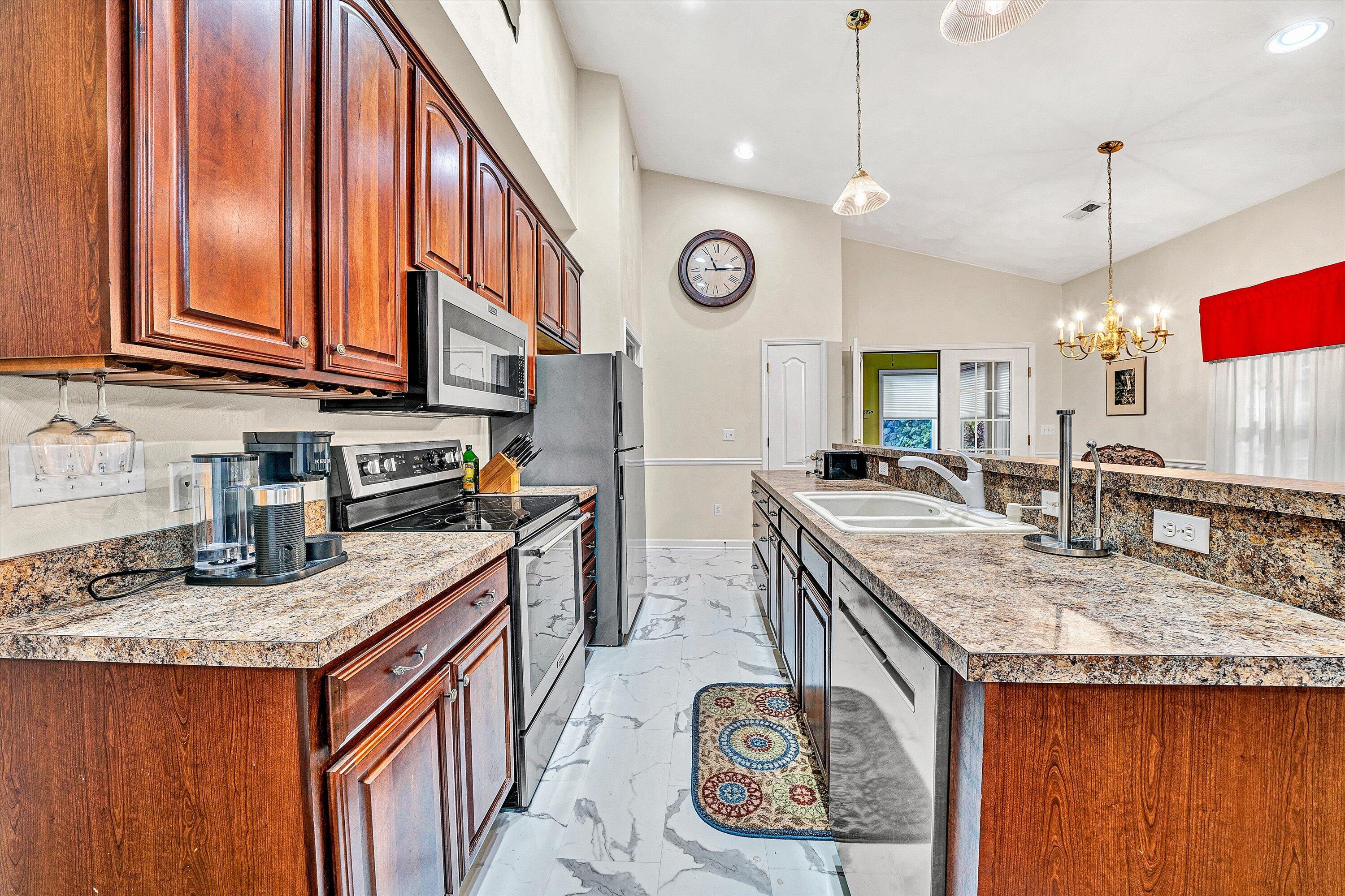 80 Stoney Mill Road Rocky Mount, VA 24151 - Photo 9 of 27 a kitchen with stainless steel appliances granite countertop a sink a stove and a wooden cabinets