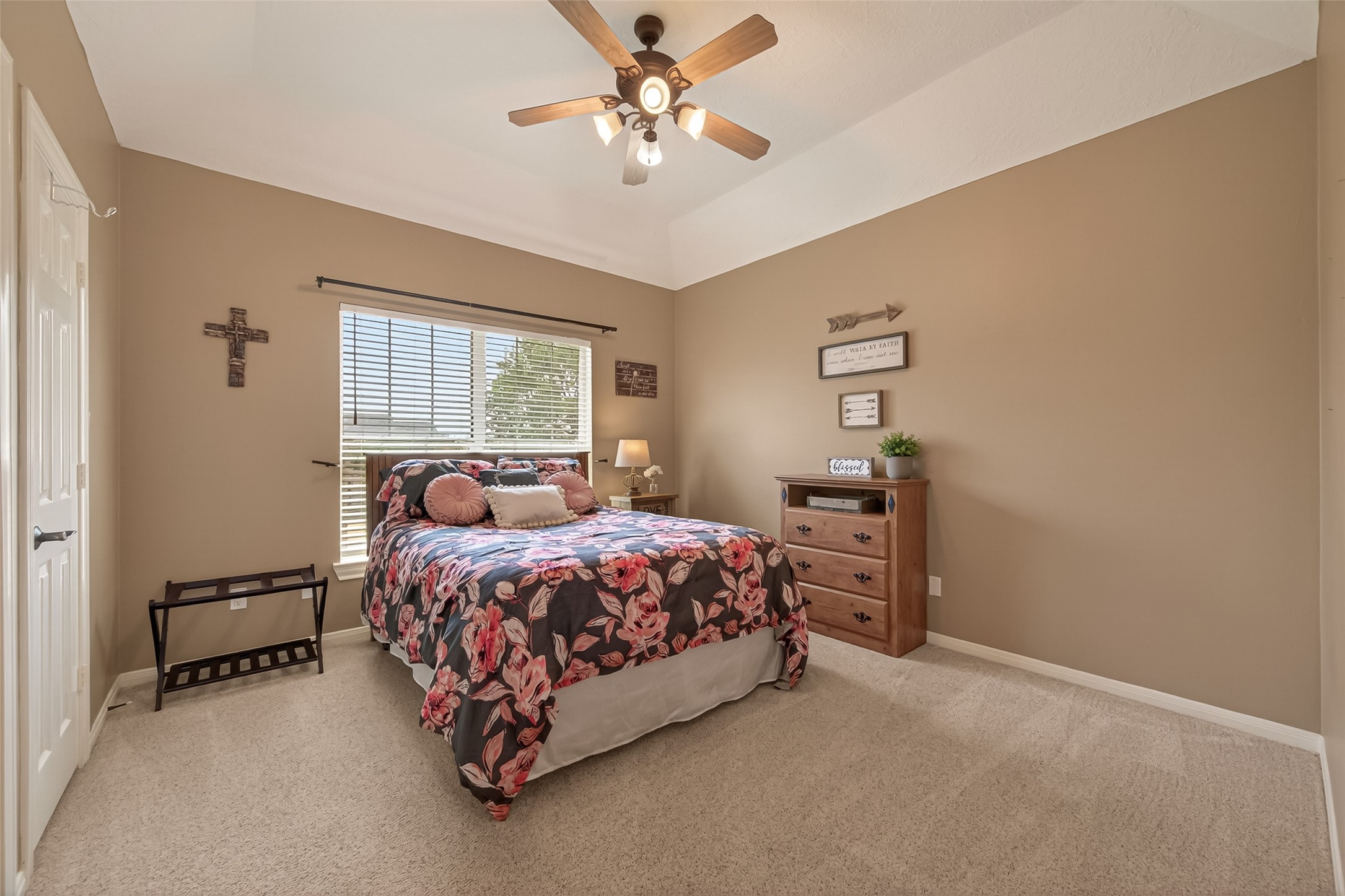 2319 Braer Ridge Drive Katy, TX 77494 - Photo 33 of 50 a bed sitting in a bedroom next to a window with a chandelier