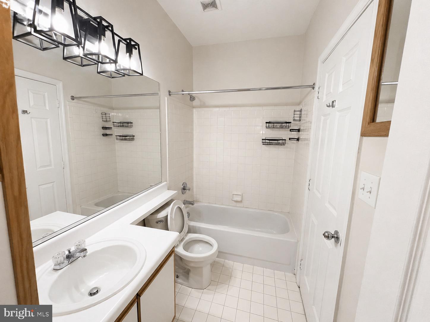601 Forest Walk Lane, Unit 103 Odenton, MD 21113 - Photo 17 of 20 a bathroom with a sink a toilet and shower