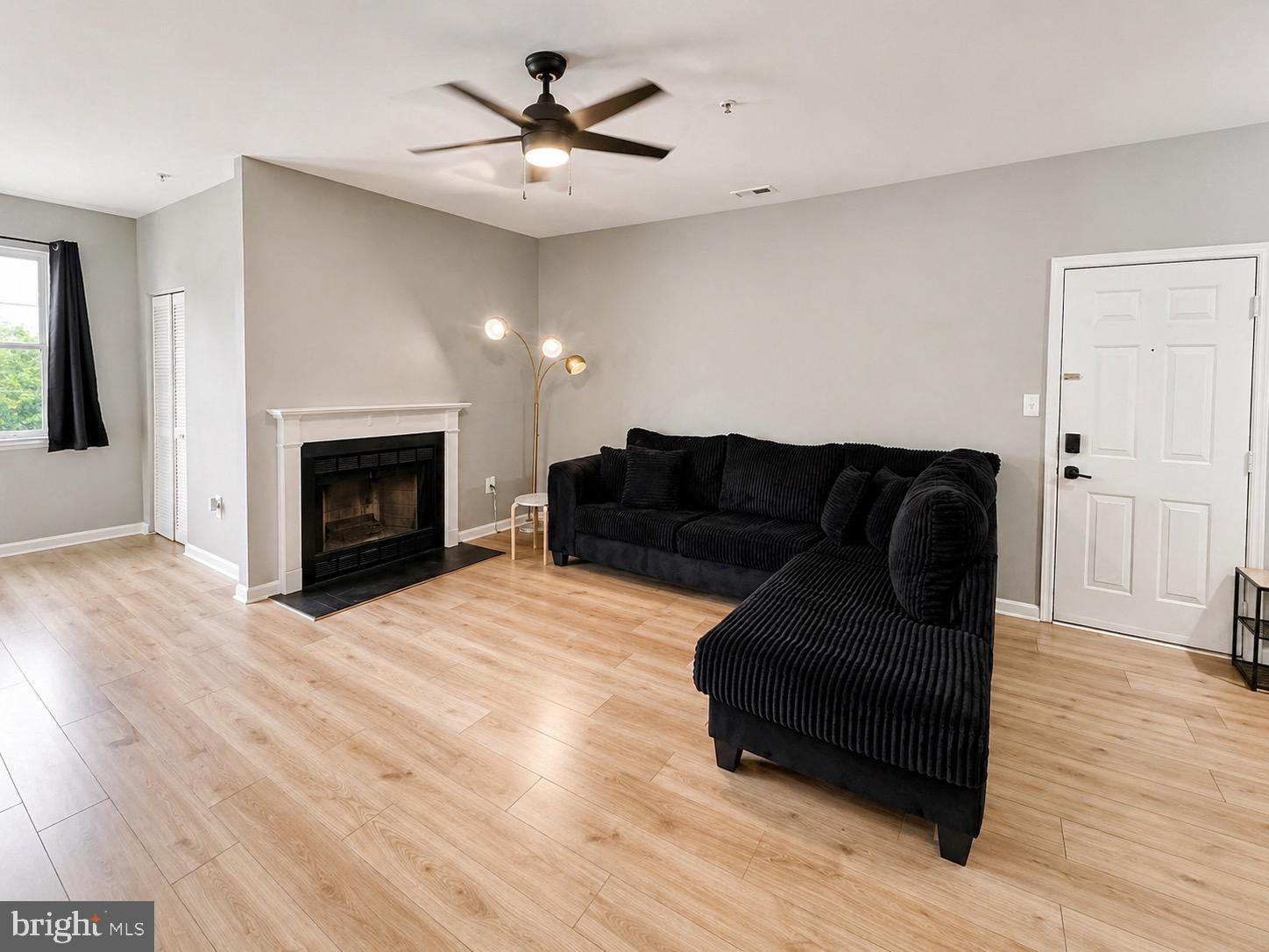 601 Forest Walk Lane, Unit 103 Odenton, MD 21113 - Photo 3 of 20 a living room with furniture and a fireplace