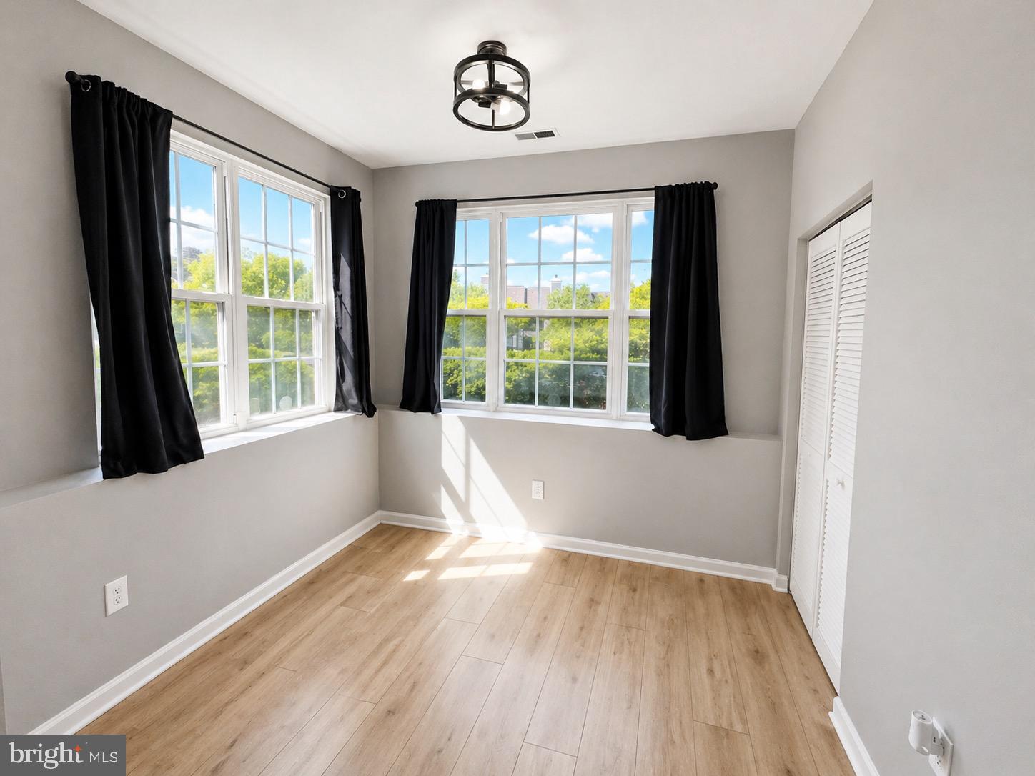 601 Forest Walk Lane, Unit 103 Odenton, MD 21113 - Photo 6 of 20 a view of an empty room with wooden floor and a window