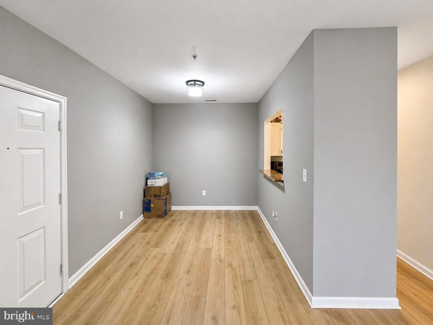 601 Forest Walk Lane, Unit 103 Odenton, MD 21113 - Photo 7 of 20 a view of empty room with wooden floor