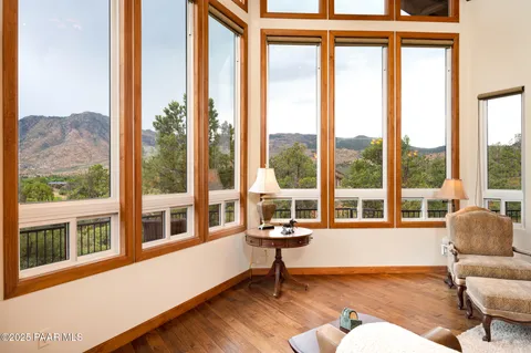 a view of a dining room with furniture large windows and wooden floor