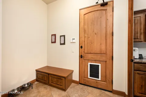 a living room with furniture a table and a large window