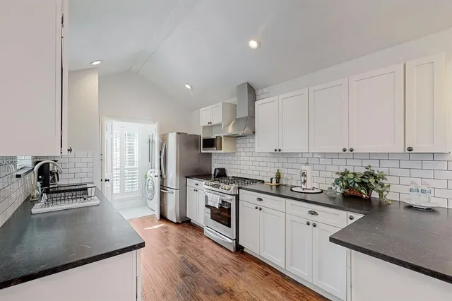 a kitchen with a sink a stove and cabinets