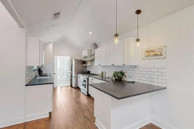 a kitchen with kitchen island a white counter top space a sink and appliances