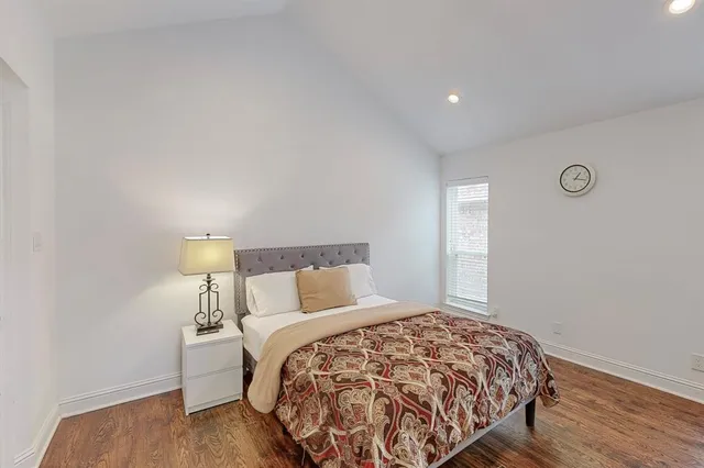 a bedroom with a bed and a night stand