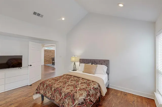 a bedroom with a bed and flat screen tv