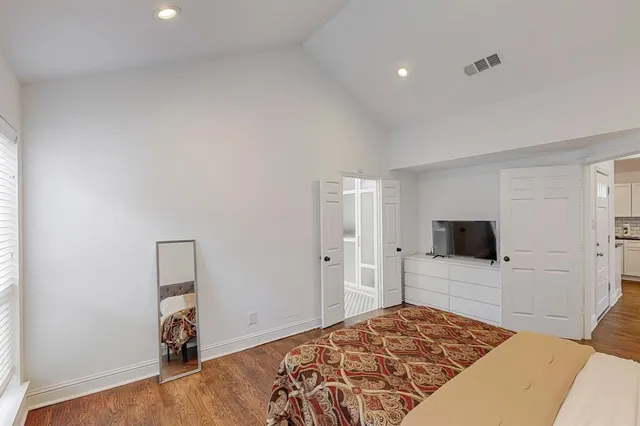 a bedroom with a bed and a flat screen tv
