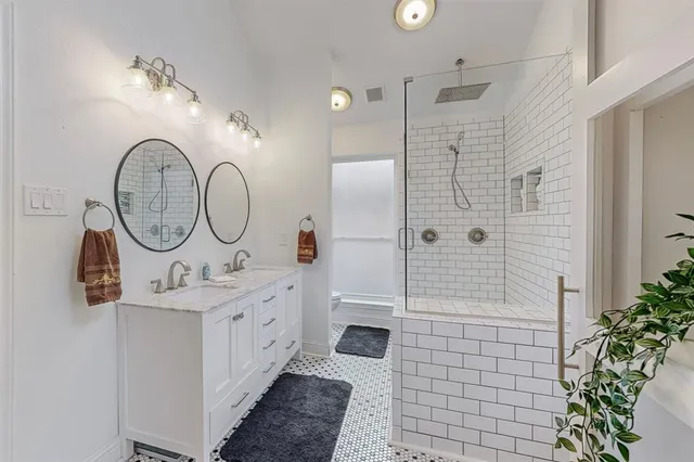 a bathroom with a sink a mirror and a shower