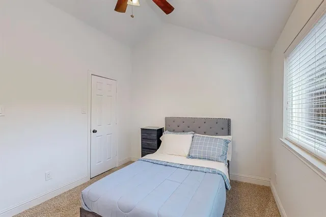 a bedroom with a bed and a window