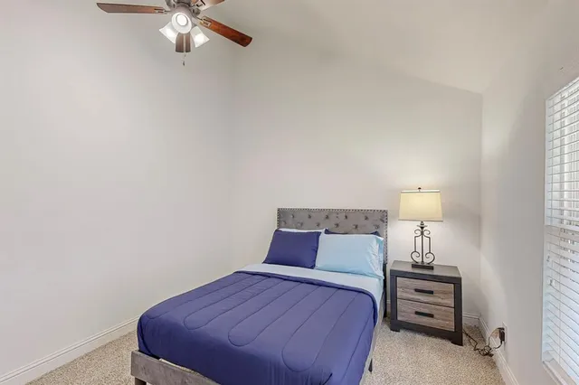 a bedroom with a bed and a lamp