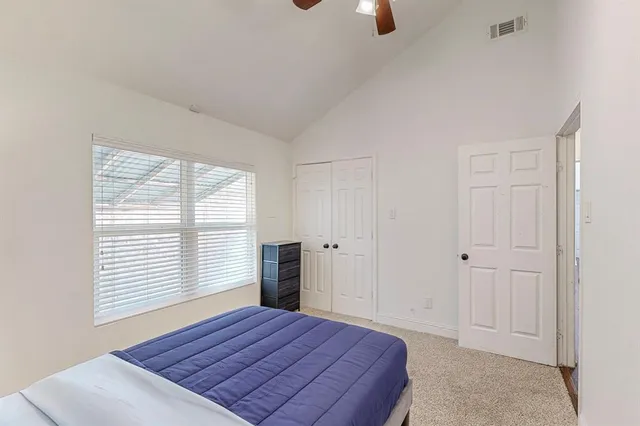 a bedroom with a bed and a window