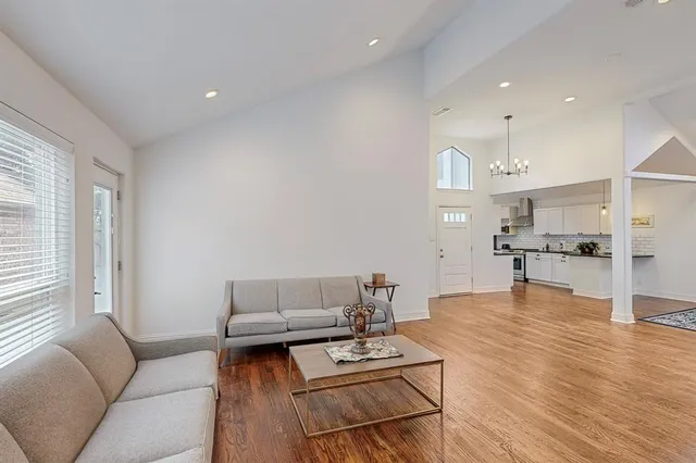 a living room with furniture and kitchen view