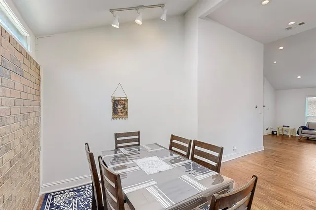 a view of a workspace with furniture and wooden floor