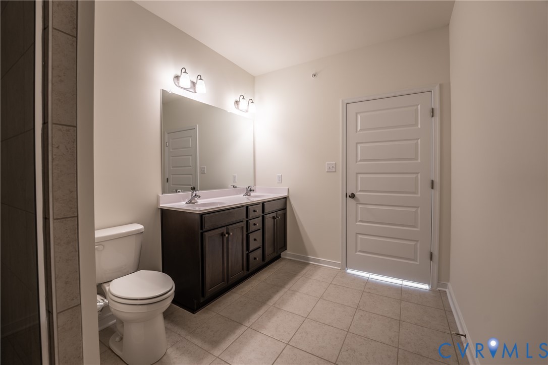 4003 Next Level Trace Midlothian, VA 23112 - Photo 20 of 38 a bathroom with a sink a toilet and shower