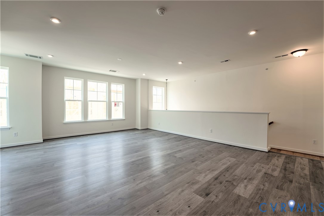 4003 Next Level Trace Midlothian, VA 23112 - Photo 3 of 38 an empty room with wooden floor and windows