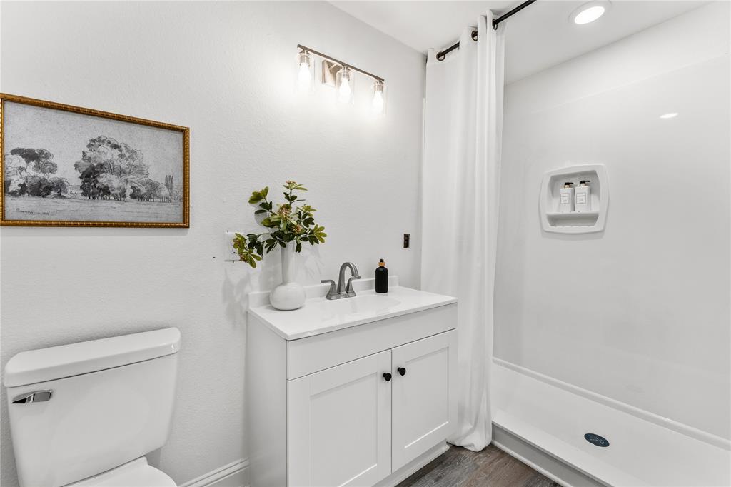 815 Garrison Street Waco, TX 76704 - Photo 21 of 36 a bathroom with a shower sink vanity and toilet