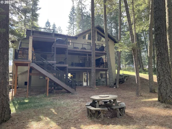 a view of a house with backyard and sitting area