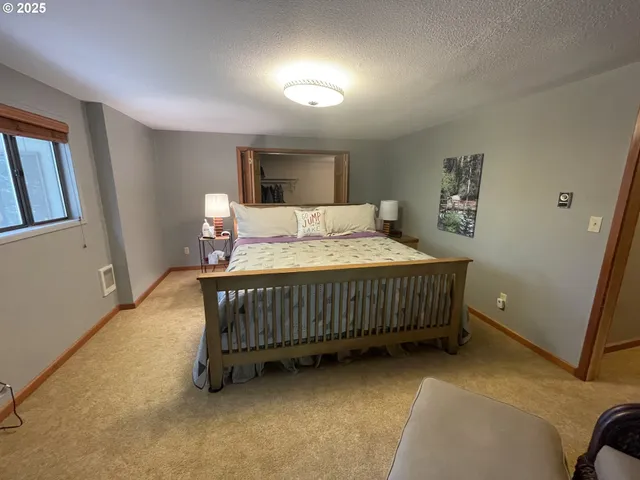 a bedroom with a bed window and a table