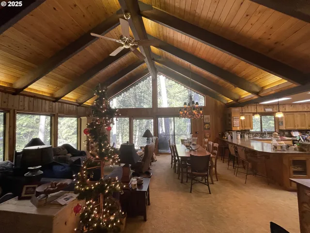 a living room with lots of furniture and a large window