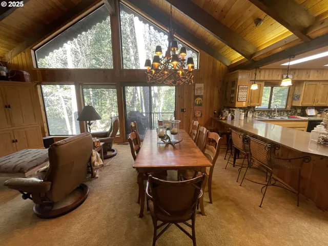 a dining room with furniture and a large window