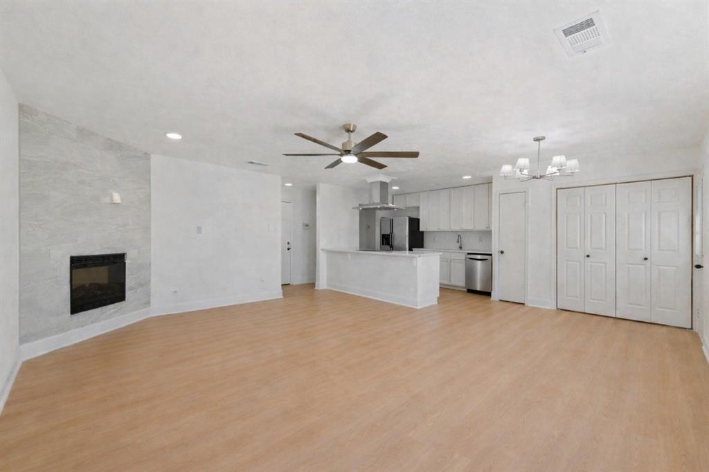 5516 Maple Lane Rowlett, TX 75089 - Photo 4 of 18 a view of a livingroom with kitchen view and a fireplace