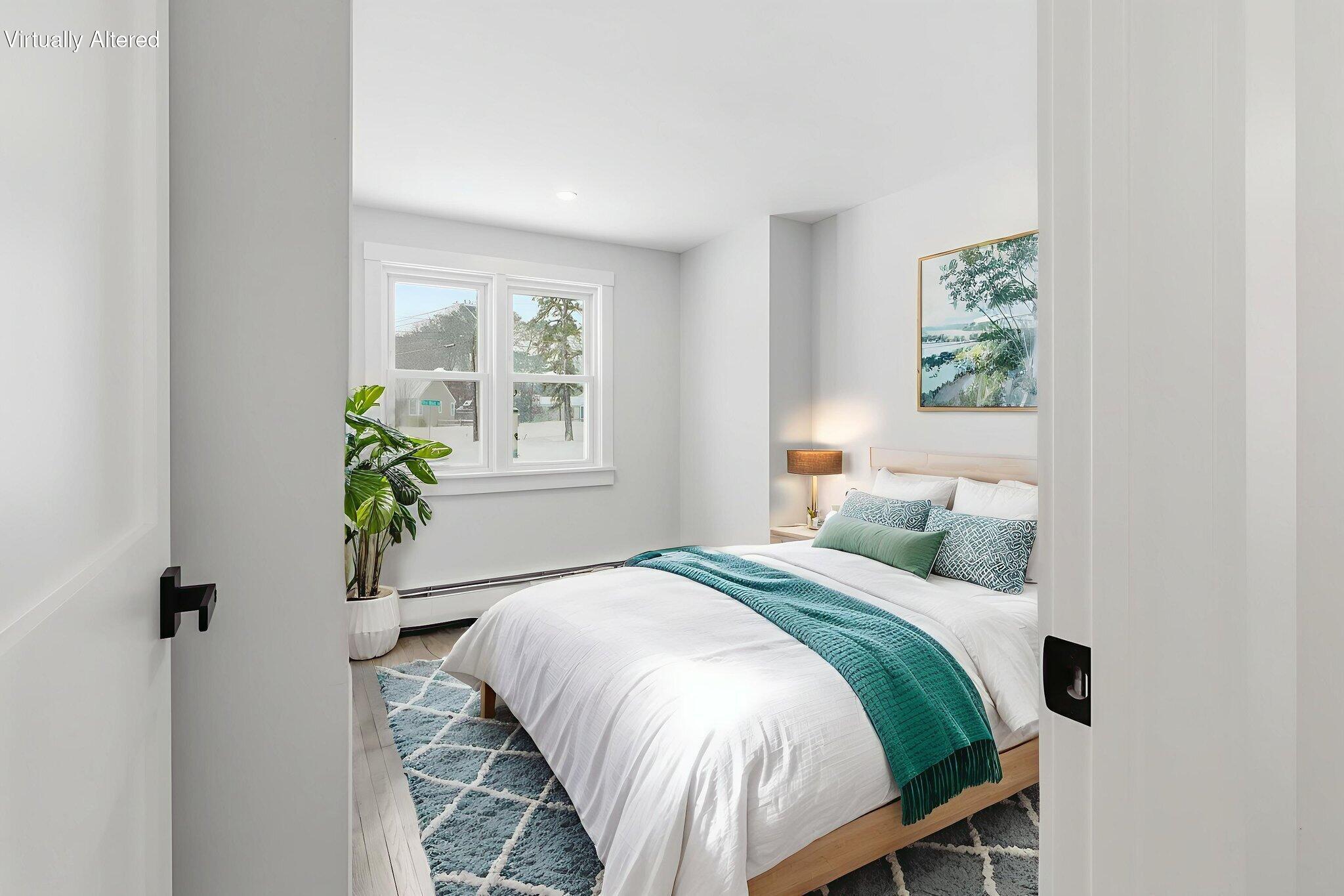 24 Hazelmoor Road South Yarmouth, MA 02664 - Photo 11 of 19 a bedroom with a bed and a potted plant