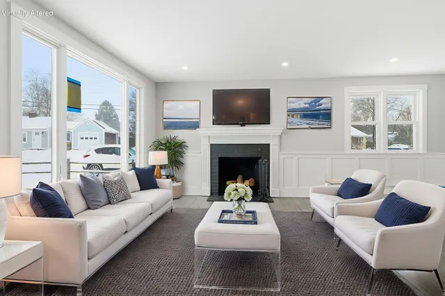 a living room with furniture and a fireplace