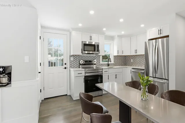 a kitchen with cabinets stainless steel appliances and a counter space