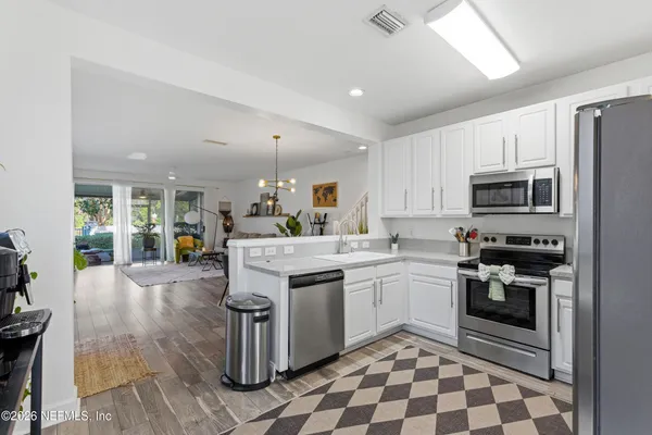 a kitchen with stainless steel appliances granite countertop a sink stove and cabinets
