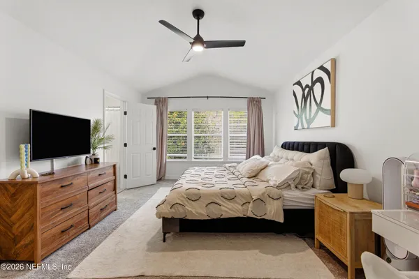 a bedroom with furniture and flat screen tv