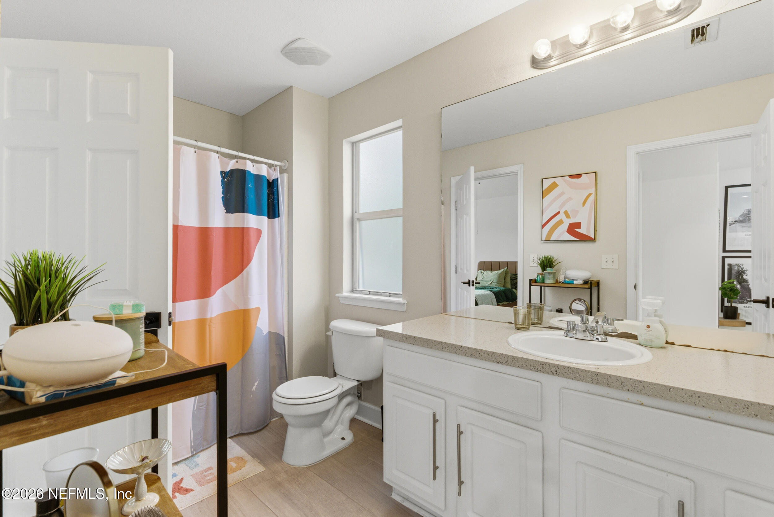 7990 Baymeadows Road, Unit 1801 Jacksonville, FL 32256 - Photo 29 of 48 a bathroom with a granite countertop sink mirror vanity and toilet