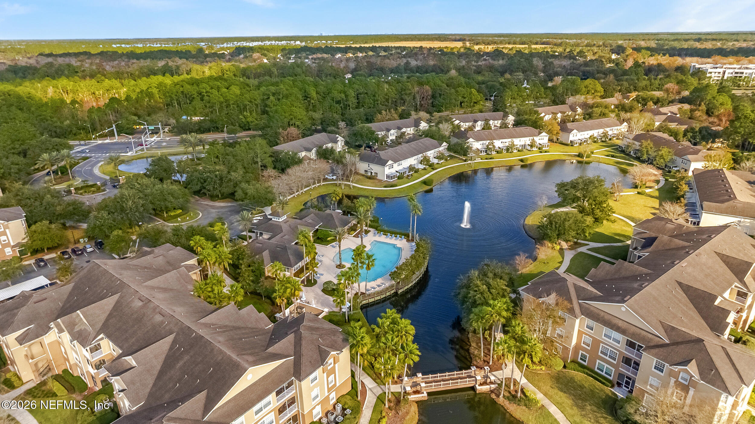 7990 Baymeadows Road, Unit 1801 Jacksonville, FL 32256 - Photo 32 of 48 a view of a swimming pool with a table and chairs