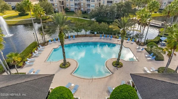 an aerial view of a house with yard swimming pool and outdoor seating