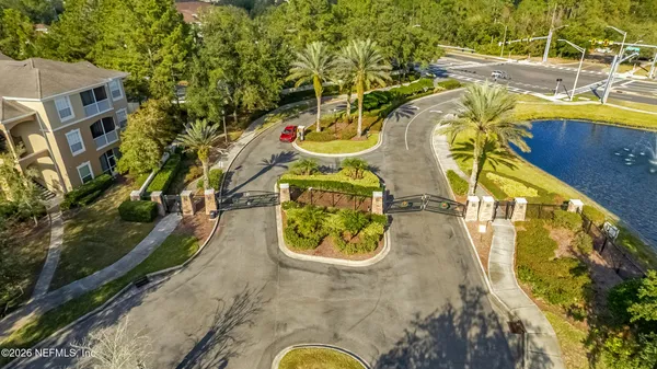 an aerial view of a swimming pool with outdoor seating and yard