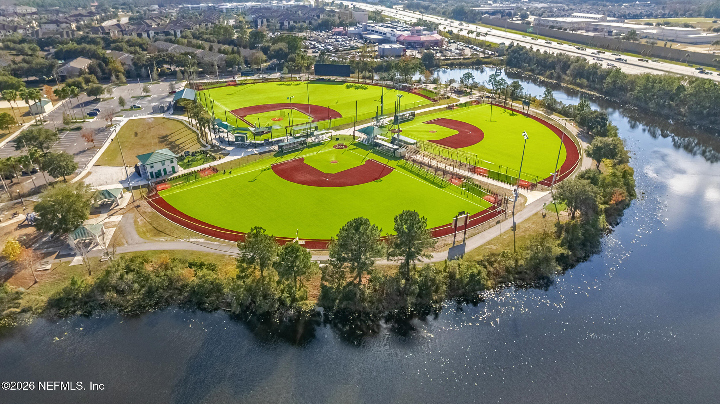 7990 Baymeadows Road, Unit 1801 Jacksonville, FL 32256 - Photo 37 of 48 an aerial view of a swimming pool with outdoor seating and yard
