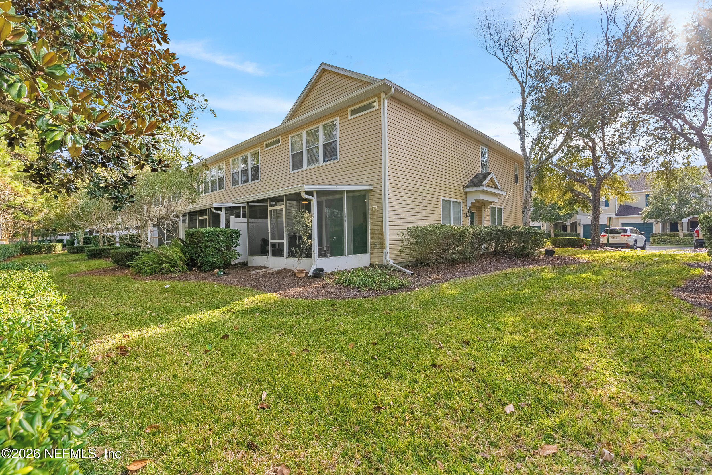 7990 Baymeadows Road, Unit 1801 Jacksonville, FL 32256 - Photo 39 of 48 a front view of a house with a yard and trees